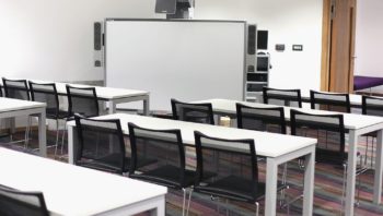 White educational furniture including large board